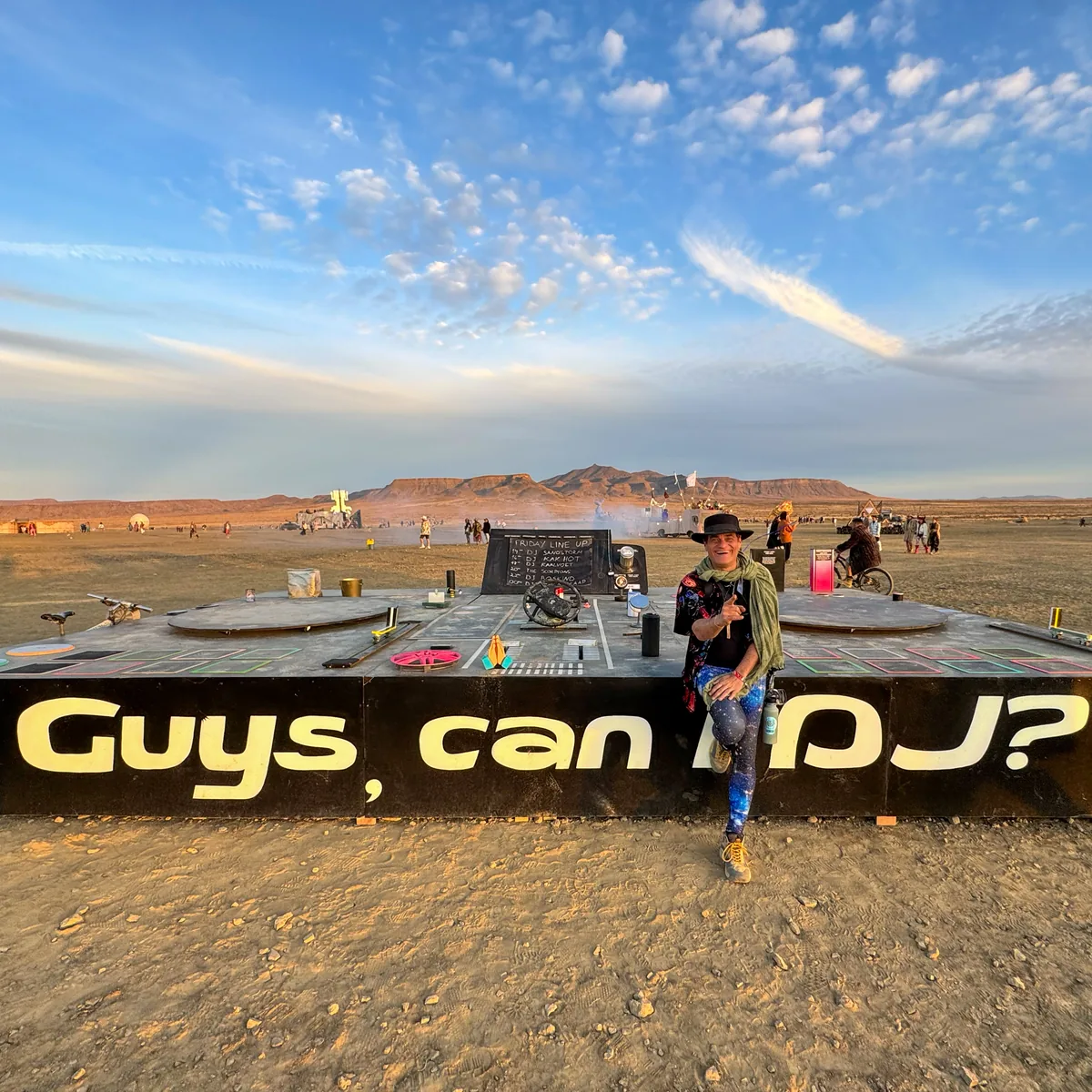 Piccaya beside a DJ stage in the desert